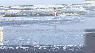 My neighbor loses her clothes at the beach.