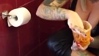 Blonde tattooed milf eats spaghetti on the toilet