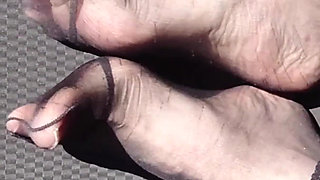 Feet of Nylonjunge in Pantyhose in Car