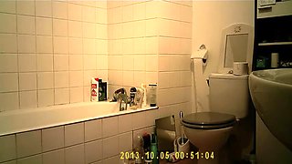 Brunette uses the toilet and takes a shower