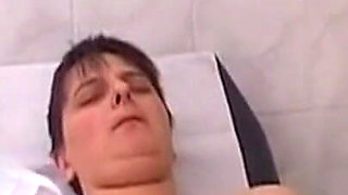 Mature Nurses Intimately Explore Patient on Exam Table
