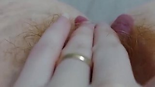 Close up video of a horny redhead fingering her hairy pussy