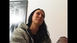 Brunette slut fingers her wet pussy on casting couch