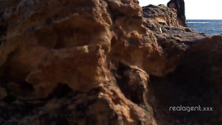 Alone lush Russian babe toys her cunt on the rock on the sea shore